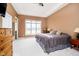 Spacious main bedroom featuring a large window providing plenty of natural light and tray ceiling at 14020 Quarter Horse Ct, Carmel, IN 46032
