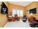 Home office featuring an oversized leather chair, work desk, TV, and natural lighting at 14020 Quarter Horse Ct, Carmel, IN 46032