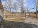 Large backyard featuring a gravel area and a concrete barrier with a chain-link fence providing enclosure at 1420 E Market St, Indianapolis, IN 46201