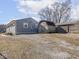 Backyard with gray house, gravel area, a weathered shed and blue sky backdrop at 1420 E Market St, Indianapolis, IN 46201