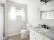 Bright bathroom with marble vanity, white cabinets, and black fixtures at 1420 E Market St, Indianapolis, IN 46201
