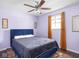 Cozy bedroom with blue bed, ceiling fan, warm curtains, and decorative wall art at 1420 E Market St, Indianapolis, IN 46201