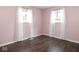 Bright bedroom with hardwood floors, pink walls, and white trim at 1420 E Market St, Indianapolis, IN 46201