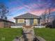 Charming bungalow with a welcoming front porch and well-maintained lawn at 1420 E Market St, Indianapolis, IN 46201