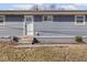 Front exterior with a gray siding, white front door, and a small landscaped area at 1420 E Market St, Indianapolis, IN 46201