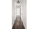 Hallway with dark wood floors, white walls, and white doors at 1420 E Market St, Indianapolis, IN 46201