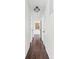 Bright hallway with hardwood floors, white walls, and a decorative light fixture at 1420 E Market St, Indianapolis, IN 46201