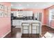 Modern kitchen with stainless steel appliances, white cabinets, a center island, and marble countertops at 1420 E Market St, Indianapolis, IN 46201