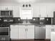 Modern kitchen with stainless appliances, white cabinets, and granite countertops at 1420 E Market St, Indianapolis, IN 46201
