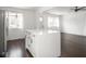 Open kitchen featuring center island, white cabinets, and hardwood floors at 1420 E Market St, Indianapolis, IN 46201