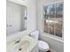 Well-lit bathroom featuring a modern vanity, a large mirror and natural light from a window at 1535 Arbor Springs Dr, Brownsburg, IN 46112