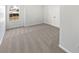 Spacious bedroom with plush carpet, window with view, and closet doors at 1535 Arbor Springs Dr, Brownsburg, IN 46112