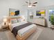 Calm main bedroom with a ceiling fan, neutral decor, and a large window view at 1535 Arbor Springs Dr, Brownsburg, IN 46112