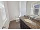 A well-lit bathroom with granite counters and dark wood cabinets at 1670 Rossmay Dr, Westfield, IN 46074