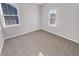 A bright bedroom with neutral carpet and multiple windows at 1670 Rossmay Dr, Westfield, IN 46074