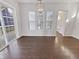 Bright dining area with hardwood floors, large windows, and access to the backyard at 1670 Rossmay Dr, Westfield, IN 46074