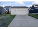 Detached two-car garage with a long driveway and well-manicured lawn at 1670 Rossmay Dr, Westfield, IN 46074