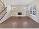 Spacious living room showcasing hardwood floors, fireplace, and ample natural light at 1670 Rossmay Dr, Westfield, IN 46074