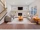 Bright living room with a fireplace, built-in shelving, and neutral-toned furniture at 1670 Rossmay Dr, Westfield, IN 46074