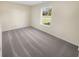 Bedroom featuring neutral walls, plush carpet and a large window looking out to the landscape at 170 Trails End, Brownsburg, IN 46112