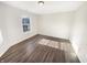 A bright bedroom with neutral walls, wood-look flooring, and a large window allowing plenty of sunlight at 170 Trails End, Brownsburg, IN 46112
