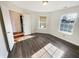Bright bedroom featuring wood-look flooring, complemented by natural light streaming through the two large windows at 170 Trails End, Brownsburg, IN 46112