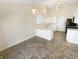Open kitchen with white cabinets, a breakfast bar, and modern lighting fixtures at 170 Trails End, Brownsburg, IN 46112