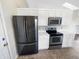 Kitchen featuring stainless steel appliances, white cabinets, white counter tops and tile flooring at 170 Trails End, Brownsburg, IN 46112