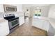 Modern kitchen with stainless steel appliances and white countertops, connected to backyard patio at 170 Trails End, Brownsburg, IN 46112