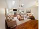 Bright living room with hardwood floors, fireplace, skylights, and neutral furniture at 170 Trails End, Brownsburg, IN 46112