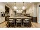 Bright kitchen boasts a large center island with seating, stylish pendant lighting, and premium stainless appliances at 1813 Milford St, Carmel, IN 46032