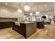 A spacious kitchen with a large central island, farmhouse sink, ample cabinetry and view into the living room at 1813 Milford St, Carmel, IN 46032