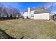 Wide backyard view with shed, deck, and lawn, surrounded by a wooden fence and neighboring houses at 1905 Windsor Ln, Danville, IN 46122