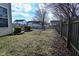 Green backyard with a wooden fence, grass and trees at 1905 Windsor Ln, Danville, IN 46122