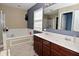 Bright bathroom features a double vanity and a large soaking tub at 1905 Windsor Ln, Danville, IN 46122
