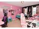 Bright bedroom adorned with lively decor, pink walls, and two gaming chairs at 1905 Windsor Ln, Danville, IN 46122