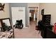 Functional bedroom with closet, neutral walls and carpet flooring; view to hallway beyond at 1905 Windsor Ln, Danville, IN 46122