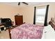 Comfortable bedroom with wood-frame bed, cozy purple blanket, and an office area at 1905 Windsor Ln, Danville, IN 46122