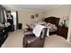 Inviting bedroom with a wooden bed frame and a comfy armchair, perfect for relaxation at 1905 Windsor Ln, Danville, IN 46122