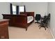 Comfortable bedroom with dark wood furnishings, and a dedicated office space at 1905 Windsor Ln, Danville, IN 46122