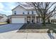 Charming two-story home with brick and siding exterior, covered porch, and attached two-car garage at 1905 Windsor Ln, Danville, IN 46122