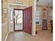 Inviting foyer with tile flooring, red front door, and view to front yard at 1905 Windsor Ln, Danville, IN 46122