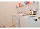 Neat laundry area with modern white washer and dryer units at 1905 Windsor Ln, Danville, IN 46122