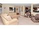 Bright living room with comfortable seating, view of kitchen, and neutral carpet at 1905 Windsor Ln, Danville, IN 46122