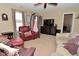 Inviting living room showcasing comfortable seating, ceiling fan, and a television at 1905 Windsor Ln, Danville, IN 46122