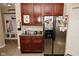 Practical mudroom with built-in storage and stainless steel refrigerator, perfect for staying organized at 1905 Windsor Ln, Danville, IN 46122
