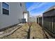 Narrow side yard featuring a fence, an AC unit, and access to a backyard gate at 1905 Windsor Ln, Danville, IN 46122