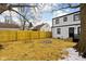 View of the large fenced backyard with a fire pit and a mature tree at 1912 Glenridge Dr, Indianapolis, IN 46218