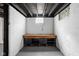 Basement workshop featuring a workbench, storage, and painted walls at 1912 Glenridge Dr, Indianapolis, IN 46218