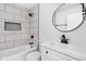 Modern bathroom featuring subway tile, dark fixtures and round mirror at 1912 Glenridge Dr, Indianapolis, IN 46218